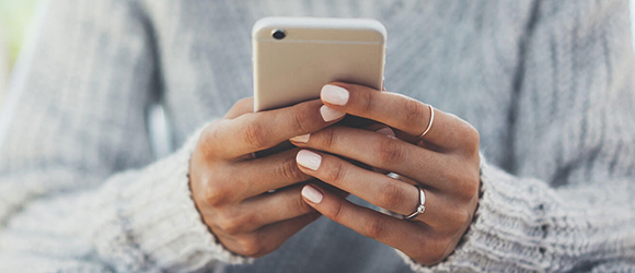 Woman holding cell phone.